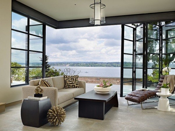 A lakefront living room with large windows.
