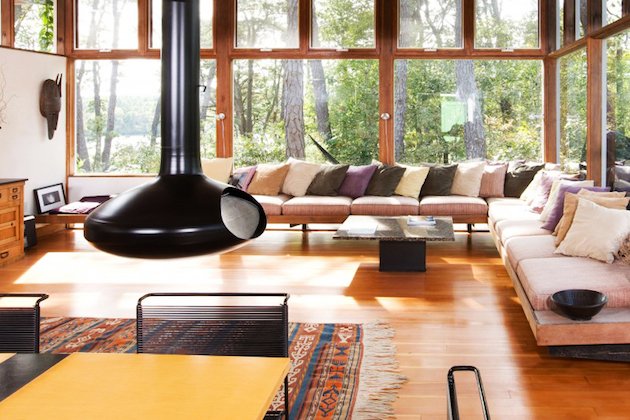 Lake Home Interiors: A living room with large windows and a wooden floor.