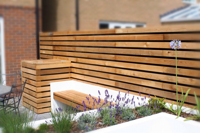 A stylish wooden slatted fence for modern outdoor spaces.