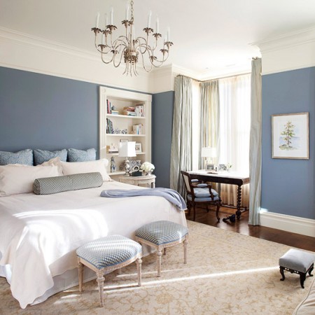 A serene and restful master bedroom with blue walls.