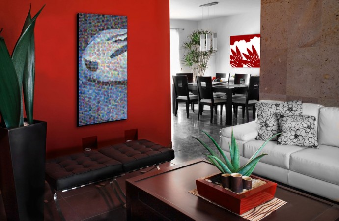 A modern living room with a red wall.