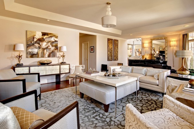 A fuss-free living room with beige furniture and a large mirror.