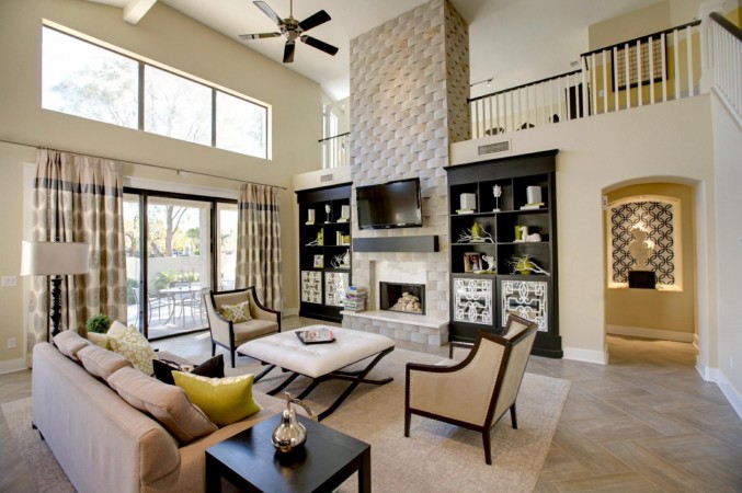 A spacious living room featuring a fireplace and ample natural light from large windows.