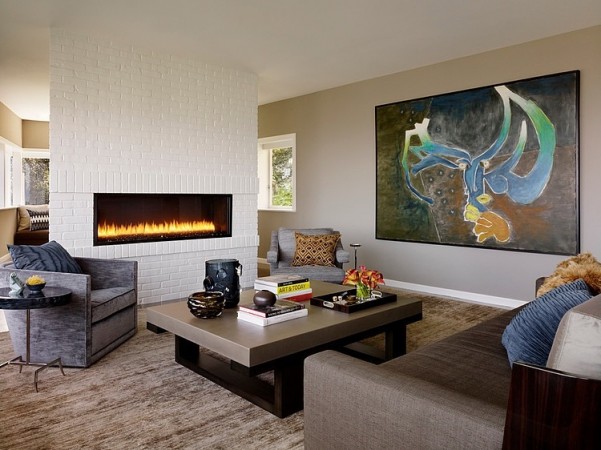Modern living room with a fireplace and art on the wall.