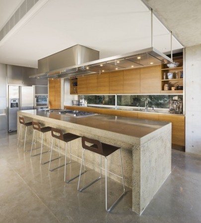 A modern kitchen with a large island and bar stools offers stylish functionality.