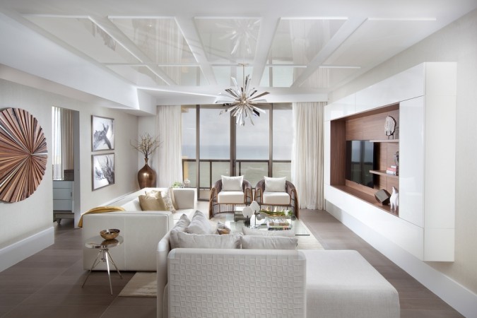 Glossy white ceilings enhance this white living room