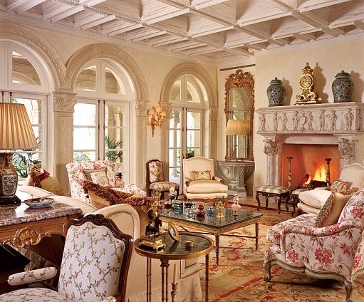 An ornate living room designed by Alexa Hampton with ornate furniture and a fireplace.