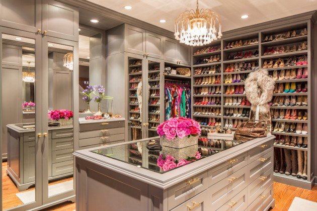 A center shelving unit provides extra space for accessories in this walk-in closet 