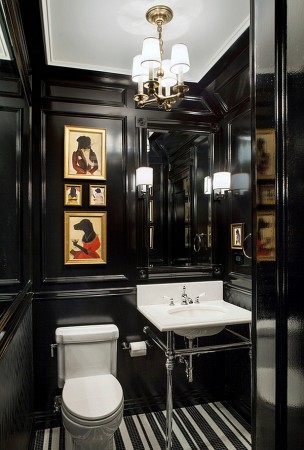 A bathroom with black walls and a unique striped floor, exuding panache.