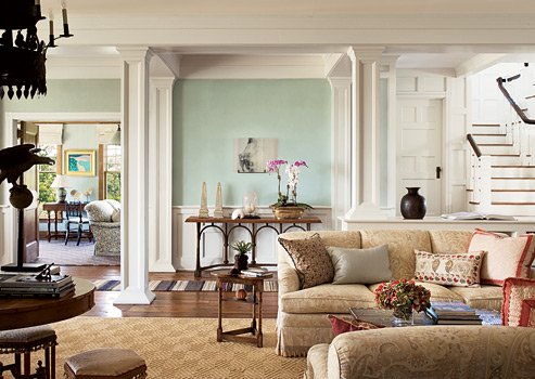 A living room with beige furniture showcasing Alexa Hampton's design expertise.
