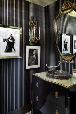 A bathroom with black and gold striped walls, perfect for powder rooms with panache.