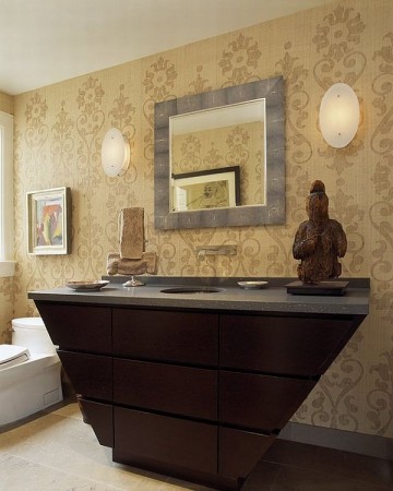 A bathroom with an ornate vanity and a buddhist statue in a powder room.