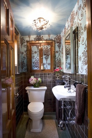 A bathroom with blue and brown wallpaper.