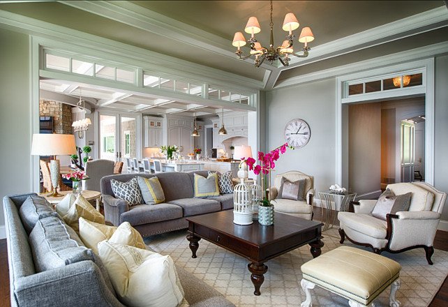 A living room with gray furniture and a chandelier, designed by Alexa Hampton.
