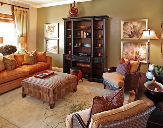 A living room with autumn-inspired interior design featuring brown furniture and a coffee table.