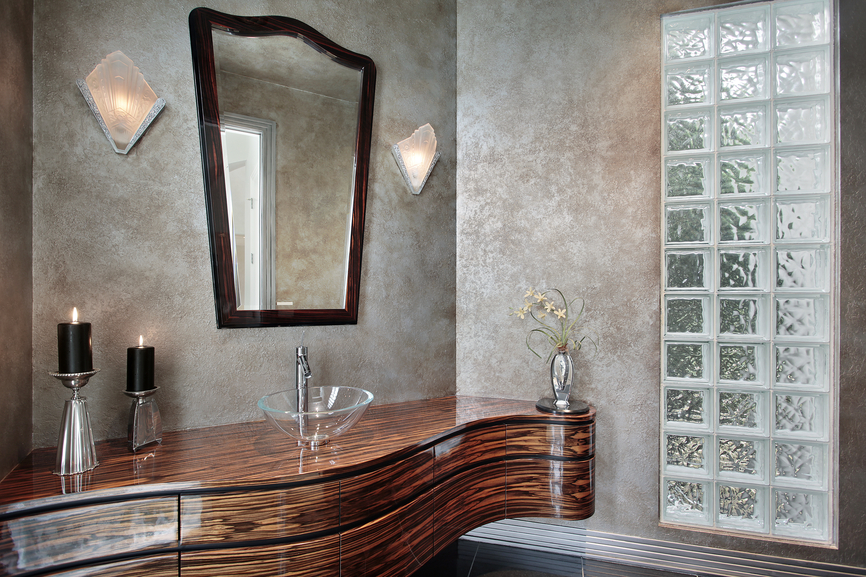 A bathroom with a wooden vanity and a mirror, designed to exude panache.