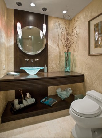 A bathroom with a toilet, sink and mirror that exudes panache.