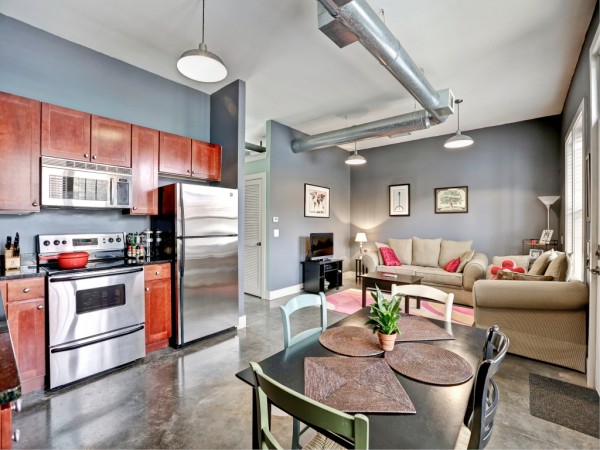 A kitchen and dining area with stainless steel appliances, perfect for enjoying an open floor plan.