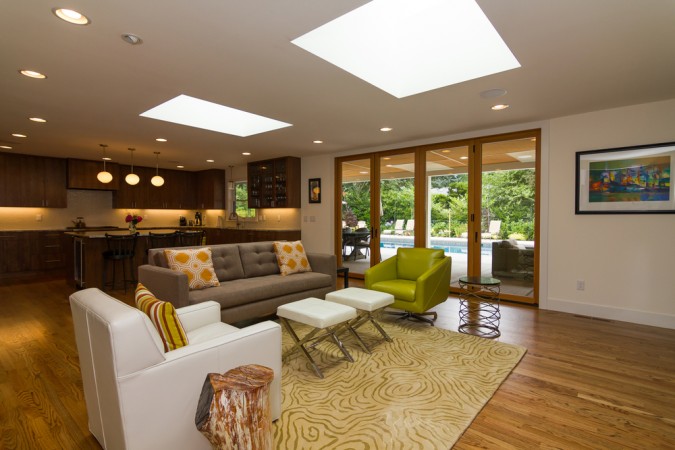 A living room with an open floor plan and a skylight.