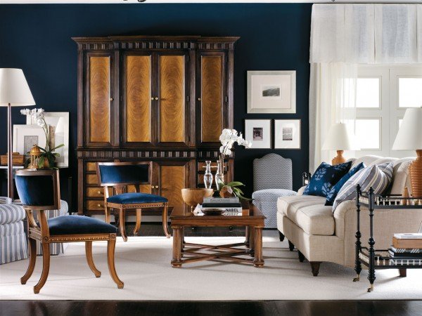 A living room with blue walls and furniture, designed by Alexa Hampton.