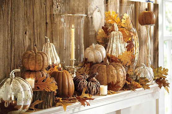 A mantle adorned with pumpkins for fall.