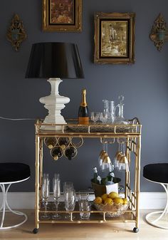 A gold bar cart in a room with blue walls, highlighting why it is a household champion.
