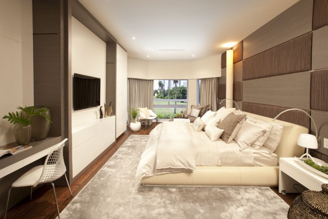 A low-profile interior design featuring a modern bedroom with a large bed.