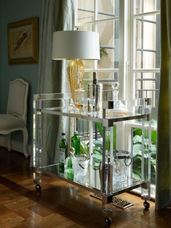 A clear bar cart, the household champion that adds style and functionality to any room with a window.