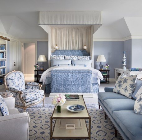 A designer blue and white bedroom.