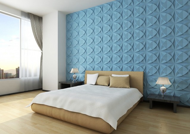 A wall of blue 3D panels infuse the bedroom with color