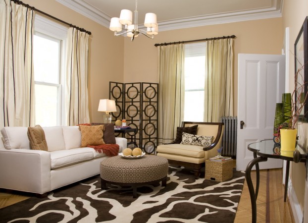 A living room with beige walls and a brown rug featuring the Versatile and Stylish Demilune Table.