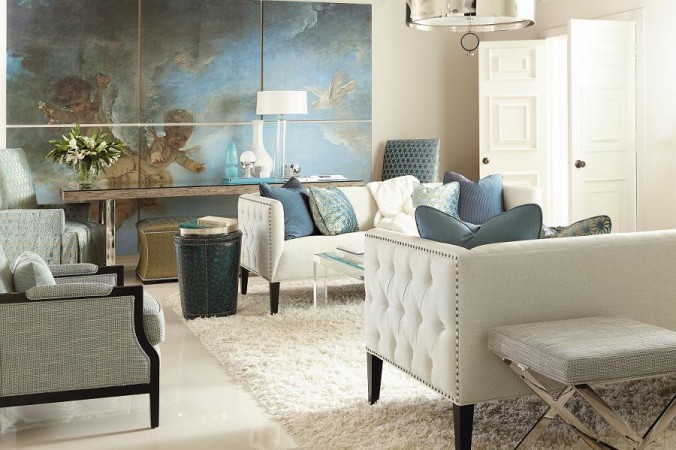 A living room with blue leather furniture and a large painting.