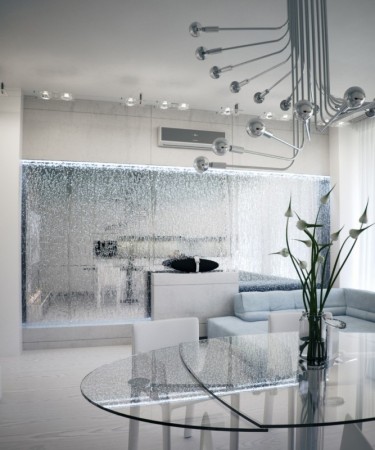 A modern dining room with a glass table and water walls.