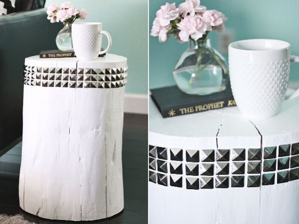 A coffee table with studs and a vase of flowers.