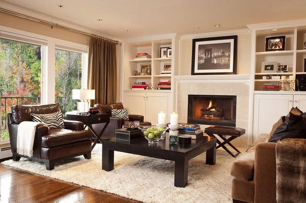 A living room with a fireplace and leather seating.