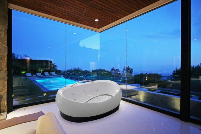 A bathtubs with an ocean view.