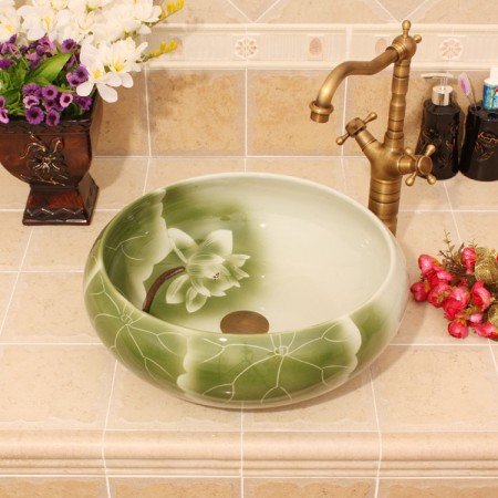 A bathroom sink adorned with green flowers.