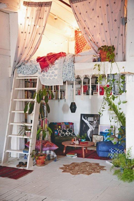 A stylish room with a loft bed and bookshelves perfect for creating the ultimate bohemian bedroom.