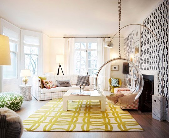 A white and yellow living room with a hanging chair, getting graphic with your interiors.
