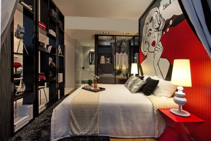 A pop art-inspired black and red bedroom with a Marilyn Monroe mural.