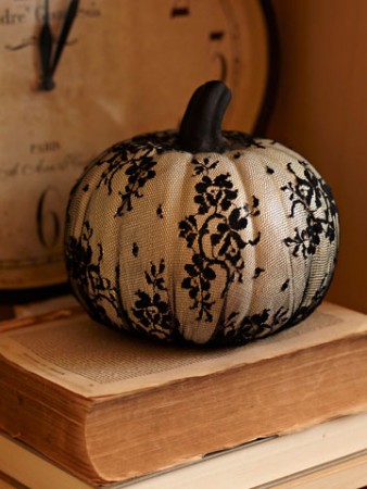 A custom carved pumpkin sitting on top of books.