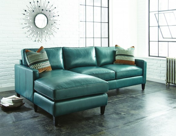 A teal leather sectional sofa exhibiting allure in a living room.