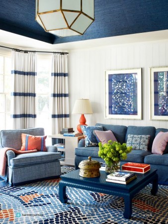 A living room with bold graphic accents in blue and orange.