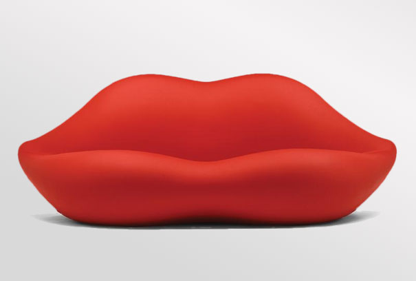 A unique sofa design featuring a red lip on a red couch.