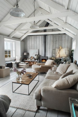 A gorgeous living room with white walls and stunning wooden beams.
