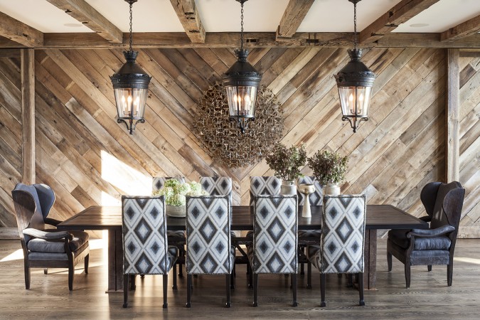 A dining room with a wooden wall, creating a graphic interior.