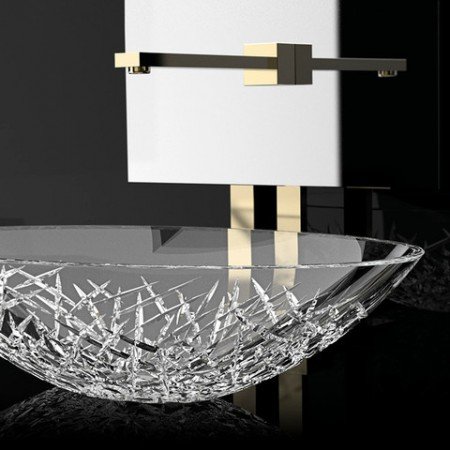 A bathroom sink with a glass bowl adorned with a gold faucet.