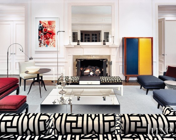 A living room with colorful furniture and a fireplace that gets graphic with your interiors.