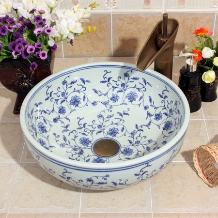 A blue and white floral patterned bathroom sink.