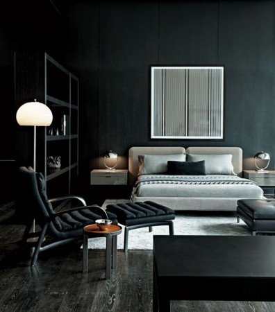 Dark walls embrace this stylish bedroom